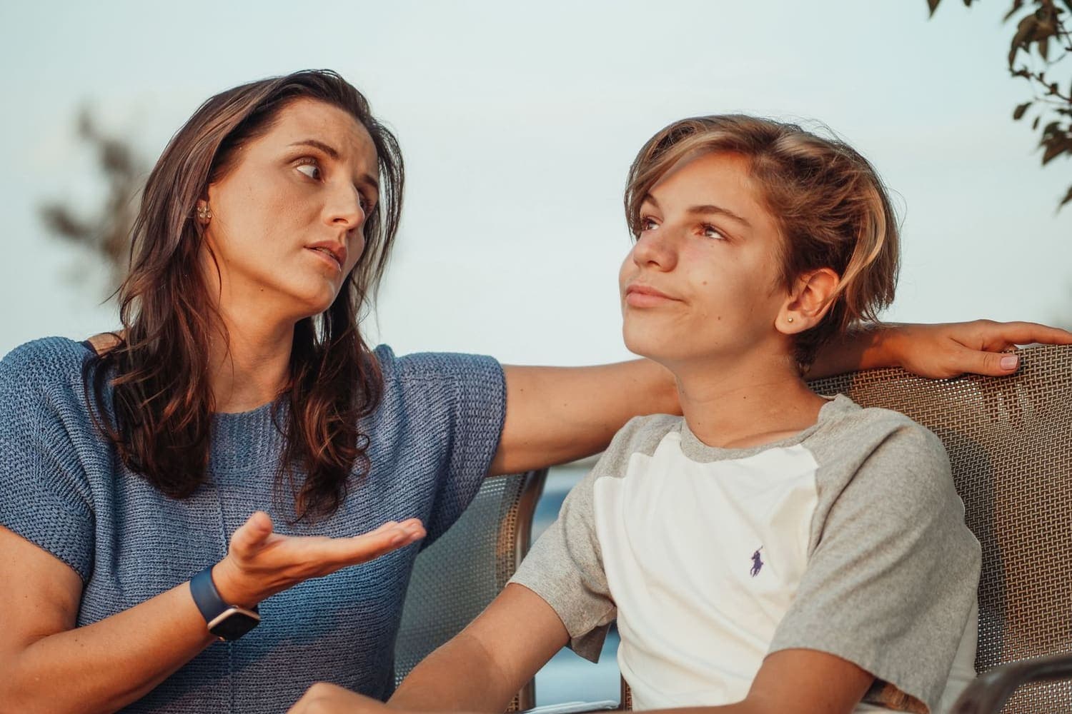 Residential care worker talking with a teenager outside a children's home